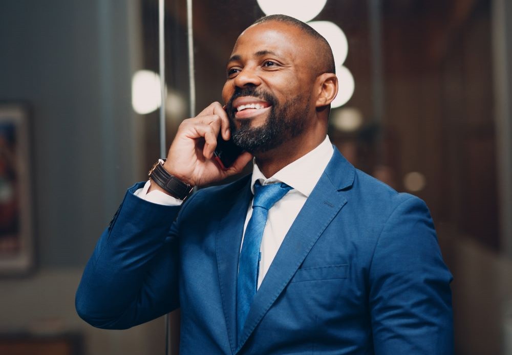 Man smiling talking over phone