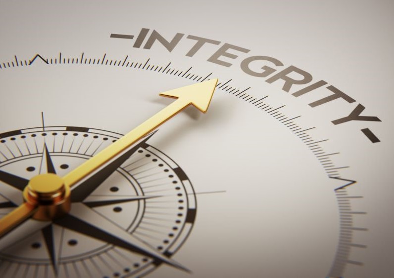 Compass with the arrow pointing to a written word Integrity